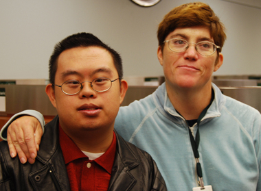 Two young people with developmental disabilities, smiling.